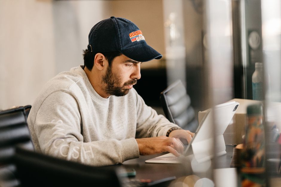 Adult sitting at a desk with a planner and coffee, reflecting on focus and daily routines